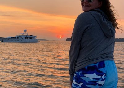 shark towel pants, sunset, girl on boat