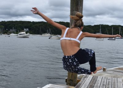 anchor pants, girl on dock jumping in the air